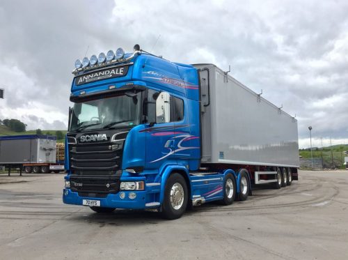 large blue hazardous goods haulage vehicle with a grey container